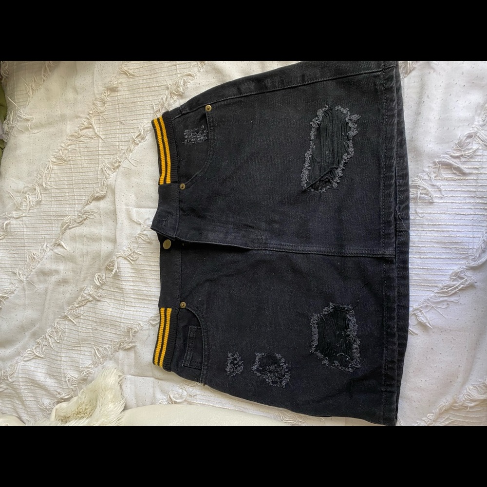 Black denim skirt. Size medium. Yellow elastic waist band.